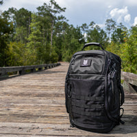 Black backpack on a wooden bridge with trees in the background