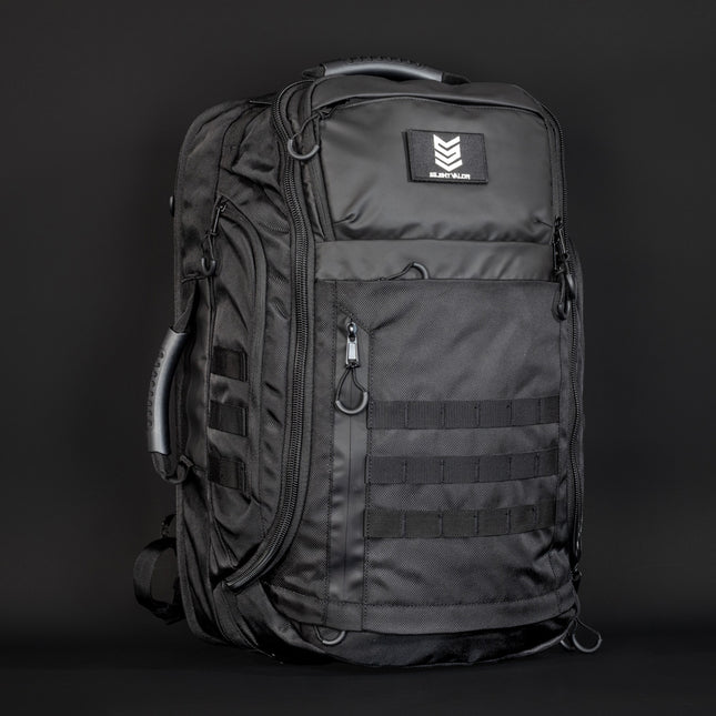 Black tactical backpack with visible brand logo on a dark background