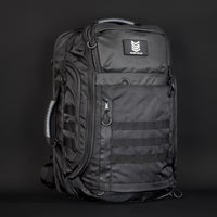 Black tactical backpack with visible brand logo on a dark background